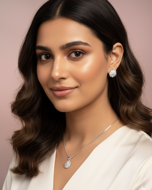 Woman wearing a necklace and earrings with a neutral background